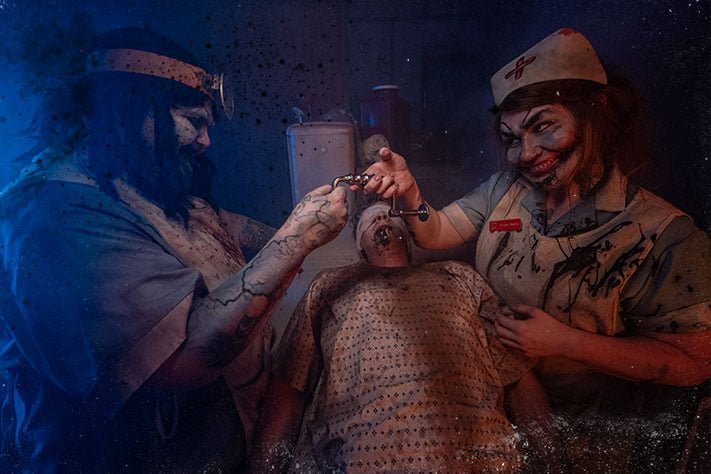 Scary doctor and nurse with patient on table